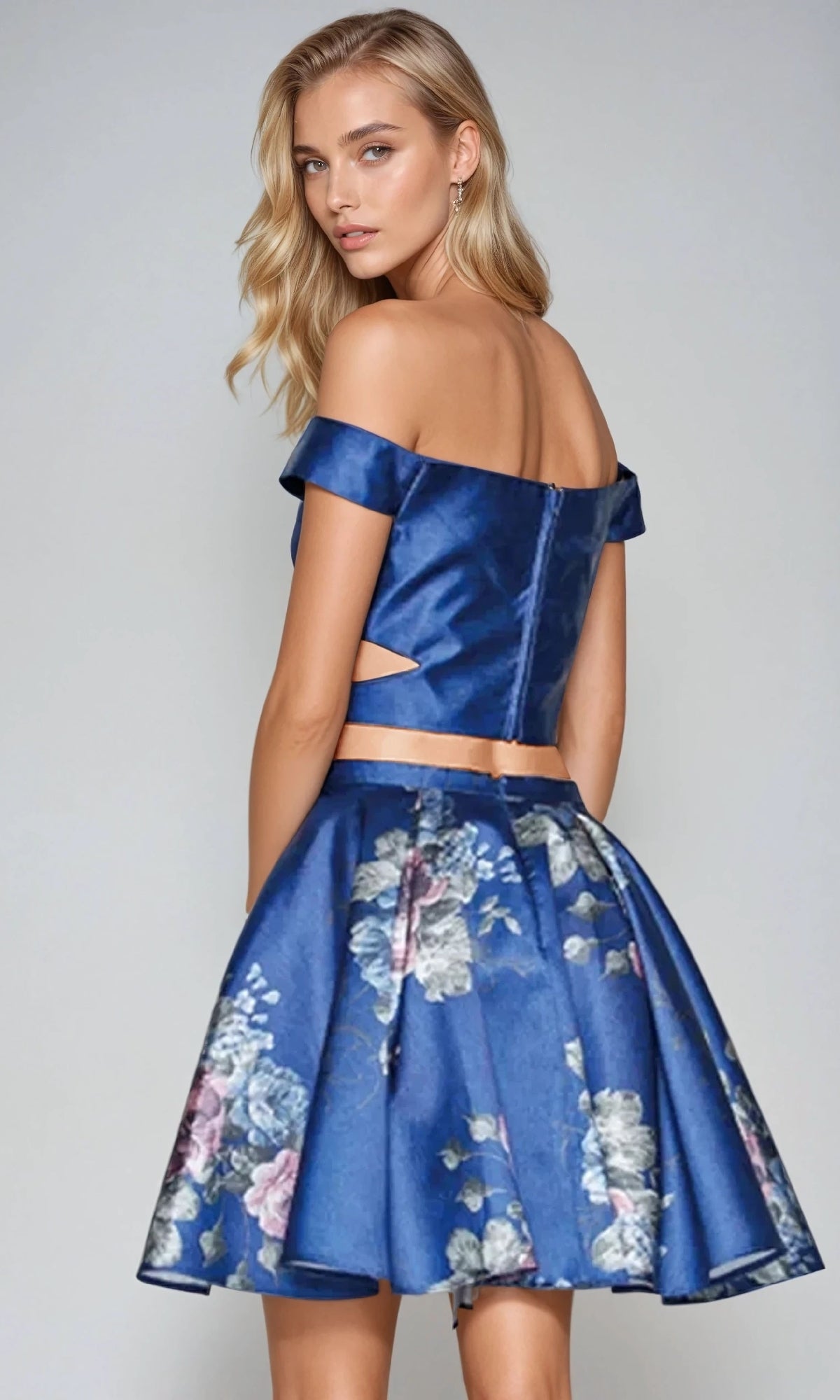 Woman wearing the Juliet 798 Short Party Dress poses with her back to the camera, looking over her shoulder against a plain background.
